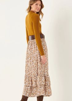 Add some country charm to your fall wardrobe with an easy fit and flowy maxi skirt. Long petticoat tiers style up this darling fall floral with comfy elastic waist silhouette. 100% Viscose Floral Print Skirted Bottoms For Fall, Casual Tiered Maxi Skirt With Floral Print, Fall Tiered Skirt With Layered Hem, Fall Tiered Ruffled Skirt, Casual Maxi Length Bottoms For Fall, Casual Maxi Length Fall Bottoms, Casual Maxi Bottoms For Fall, Fall Tiered Skirt With Ruffle Hem, Brown Tiered Skirt Bottoms For Fall