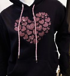 "Really special multi pink rhinestones heart design on black hoodie. Small hearts of different sizes come together to make one big heart. We make this design using pretty pink rhinestones. We use high quality rhinestones for all our designs. They are super sparkly and pictures do not do them justice! This hoodie also has a really nice rhinestone pink drawstring.  Makes a great birthday, wedding or Mother's day gift. Hoodie is made of 50cotton/50poly fleece. Super soft and comfy. Nice medium weig Black Hooded Sweatshirt Gift, Black Hooded Sweatshirt As Gift, Black Cotton Hoodie For Gift, Black Cotton Hoodie As Gift, Black Casual Hoodie As Gift, Casual Black Hoodie As Gift, Black Rhinestone Hoodie For Winter, 31 Gifts, Love Sweatshirt