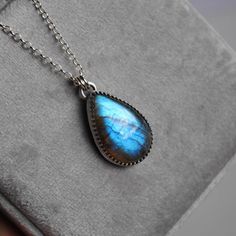 This handmade sterling silver necklace features a beautiful labradorite stone set in a unique bezel. The face of the pendant measures approximately 1 x 0.68 inches.  Choose your chain length and finish (see last photo) from the drop down menus.    ★ All orders come wrapped in a gift box, ready for gifting ★ Labradorite Gemstone Teardrop Pendant Jewelry, Teardrop Labradorite Necklace, Silver Labradorite Teardrop Pendant Jewelry, Labradorite Jewelry With Bezel Setting As Gift, Labradorite Jewelry With Bezel Setting For Gift, Untreated Teardrop Pendant Necklace As A Gift, Untreated Teardrop Pendant Necklace For Gifts, Silver Labradorite Necklace For Healing, Silver Labradorite Teardrop Pendant Necklace