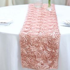 a pink table runner with roses on it