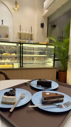 two plates with desserts on them sitting on a table