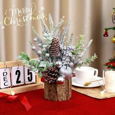 a christmas centerpiece with pine cones and silver ornaments