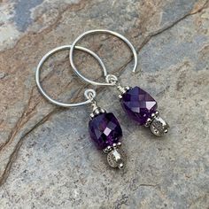 Beautiful deep, dark amethyst earrings! The 8mm faceted amethyst cubes hang from round sterling silver hoop wires with sterling silver flower stamped Hill Tribe silver beads. Your jewelry will arrive in a cotton lined kraft box within a padded postal envelope. I use USPS first class mail. This usually takes 3 to 5 days to ship. International orders outside of the U.S. will take 8 to 15 days to ship. To see more from East Village Jewelry~ http://eastvillagejewelry.etsy.com All orders ship out wit Nickel-free Purple Dangle Hoop Earrings, Purple Nickel-free Dangle Hoop Earrings, Adjustable Nickel-free Purple Hoop Earrings, Dark Amethyst, Labradorite Bracelet, Hill Tribe Silver, Flower Stamp, East Village, Sterling Silver Flowers