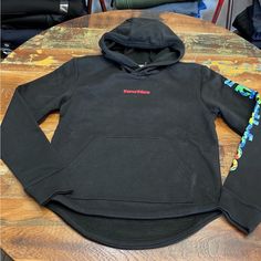 Black North Face Hoodie With Red Lettering On The Front And Brightly Colored Lettering On The Sleeve. Front Pouch Pocket. Black The North Face Hoodie For Streetwear, The North Face Black Hooded Hoodie, Black The North Face Sweatshirt For Fall, Casual Black The North Face Hoodie, Sporty Black The North Face Sweatshirt, Sporty Black Sweatshirt By The North Face, The North Face Fleece Sweatshirt With Adjustable Hood, Winter Long Sleeve Sweatshirt By The North Face, The North Face Fleece Hoodie For Streetwear