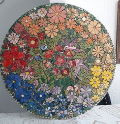 a plate with flowers painted on it sitting on a table