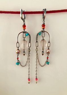 Beautiful, long, one of a kind Chandelier earrings in Sterling silver with selected beads. These earrings are part of my one of a kind collection. They are handmade out of Sterling silver and selected beads of facetted Rose quartz, Quartz Crystal, Turquoise, Carnelian, Pearl and African vinyl beads. They are a little over 3 1/2 inches long and close with a lever back ear finding. The detail and movement of these unique earrings are truly whimsical❤️. You will love these earrings if you like: - u Fusion Style Dangle Chandelier Earrings, Unique Chandelier Drop Earrings With Dangling Beads, Fusion Style Dangle Earrings For Jewelry Making, Handmade Fusion Long Drop Earrings, Handmade Fusion Style Long Drop Earrings, Handmade Fusion Style Chandelier Drop Earrings, Unique Long Drop Earrings With Dangling Beads, Handmade Dangle Crystal Earrings, Handmade Fusion Chandelier Drop Earrings