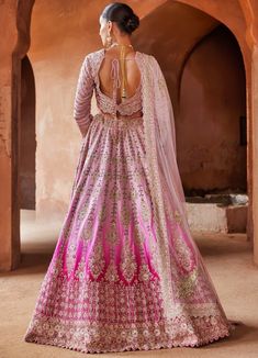 Featuring an exquisite fuchsia pink ombre dyed lehenga & dupatta set, paired with a pink raw silk blouse adorned with appliqué embellished work, overlaid with gold dabka, kasab, beads, crystals, and sequins for a touch of opulence. For added versatility, you can style the outfit with an additional pink dupatta. This ensemble is perfect for special occasions, combining vibrant colours and intricate detailing to create a stunning look. Composition : Lehenga & Blouse: Raw Silk, Dupatta: Soft Net Ca India Outfits, Ombre Dupatta, Desi Fits, Crystal Work, Lehenga Dupatta, Raw Silk Lehenga, Half Saree Lehenga, Indian Bridal Photos, Crystal Embroidery