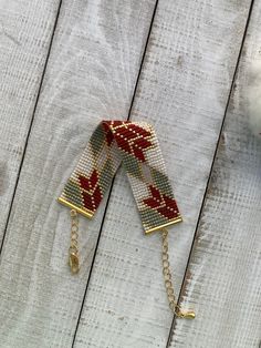 a pair of red and white beaded hair clips on a wooden surface with other accessories