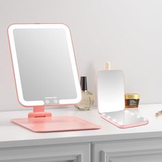 a vanity with a mirror, makeup and other items on it