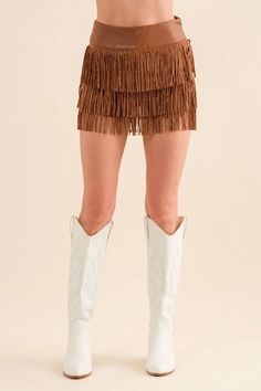 "Elevate your summer style with our Women's Wide Faux Leather Waist Fringe Shorts, a chic and edgy addition to your wardrobe. Crafted from high-quality faux leather, these shorts feature a wide waistband adorned with fringe detailing for a touch of bohemian flair. The relaxed fit and lightweight fabric ensure comfort and ease of movement, while the faux leather adds a dose of sophistication. Perfect for festivals, concerts, or nights out, these shorts are sure to make a statement. Pair them with a crop top and ankle boots for a trendy look, or dress them up with a blouse and heels for a more polished ensemble." Fitted Fringe Bottoms For Party Season, Fall Party Fitted Shorts, Fitted Party Shorts, Fitted Party Shorts For Fall, Brown Mini Skirt For Festival, Brown Bottoms For Festival, High Waist Bottoms With Fringe For Fall, High Waist Fringe Bottoms For Fall, High-waist Fringe Bottoms For Fall