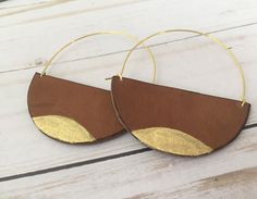 A lot of love and attention to detail went into these brown circle leather statement earrings. Leather pieces were cut into the half moon shape. Each moon was then given a tiny touch of gold paint on the bottom. The edges of the crescents were then burned to give them a darkened, rustic appearance. The ear wires were cut to length and formed into the curved shape. The ear wires are made from jeweler's bronze. These earrings measure approximately 2 5/16 x 3 inches. Thanks for checking out my earr Handmade Brown Hoop Earrings For Everyday Wear, Brown Small Hoop Earrings As Gift, Everyday Handmade Brown Hoop Earrings, Modern Brown Leather Earrings, Brown Hoop Earrings Gift, Modern Small Hoop Brown Earrings, Modern Brown Small Hoop Earrings, Brown Small Hoop Earrings For Everyday, Brown Round Hoop Earrings For Gift