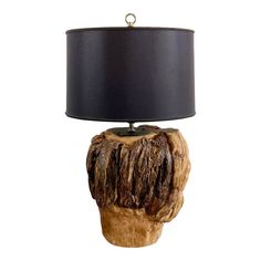 a wooden table lamp with a black lampshade on it and a dark shade