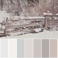 a wooden fence surrounded by snow covered ground and trees with color swatches in the foreground