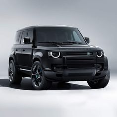 the black range rover is parked in an empty room