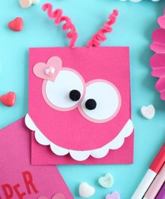 valentine's day crafts for kids made with paper and crafting supplies on a blue background