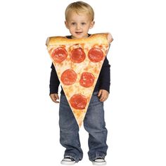 a young boy is holding up a large slice of pizza on his chest while standing in front of the camera