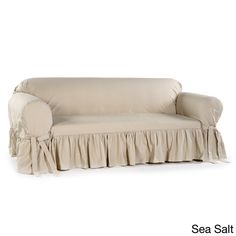 a couch with a ruffled cover on it's arm and back, sitting in front of a white background