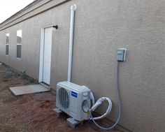 an air conditioner is attached to the side of a house