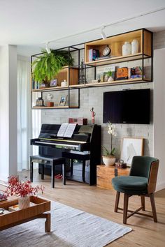 a living room filled with furniture and a piano in front of a flat screen tv