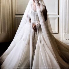 a woman in a white wedding dress and veil