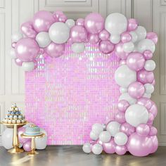 a pink and white backdrop with balloons