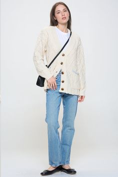 A true classic, this relaxed fit cardigan comes in a thick cable knit. Contrast pockets, a button front and boyfriend body make it the perfect addition to your fall wardrobe. Layer over a timeless white tee or wear open over just about anything. Product Details Material: 70% Polyester, 30% Acrylic. Fit: Relaxed boyfriend fit. Body length: 24" from shoulder to hem (size Small). Fabric: Thick cable knit. Features: Button front, v-neckline, boyfriend body, weaved cable knit design, contrast trimmed White Cable Knit Button-up Outerwear, Casual Relaxed Fit Cable Knit Cardigan, Classic White Cardigan With Pockets, Relaxed Fit Cable Knit Cardigan For Layering, Oversized Cotton Cable Knit Cardigan, Oversized Cable Knit Cotton Cardigan, Casual Cotton Cable Knit Cardigan, Casual Cable Knit Cardigan For Everyday, Casual Everyday Cable Knit Cardigan