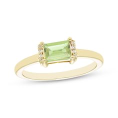 This petite ring is the perfect little pop of color to dress up your finger. Created in 10K yellow gold, the design features a baguette-cut peridot set horizontally and flanked by ribbons of diamond accents atop a slender polished shank. Senior Ring, Senior Rings, Petite Ring, Gold Book, Peridot Stone, Baguette Cut, Diamond Stone, Baguette, Ring Designs