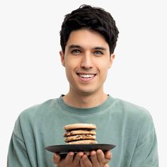 a man holding a plate with some food on it