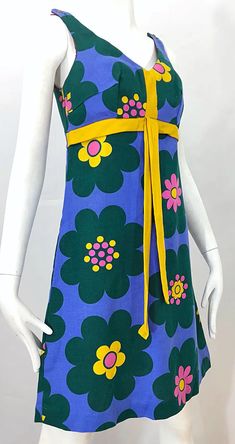 For Sale on 1stDibs - Chic 60s linen flower print sleeveless A-Line dress! Features a purple background, with pink, yellow and green flowers printed throughout. Tailored bodice 60s Floral Dress, Vintage Outfits 60s, 1960s Style Dress, Multicolor Mod Dress With Retro Print, Yellow And Green Flowers, 1970s Style Green Floral Print Dress, Multicolor Cotton Mod Dress, 70s Flower Print Dress, 1970s Style Sleeveless Floral Print Dress