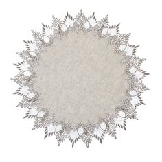 an embroidered doily with white flowers and leaves on the edges, in grey tones