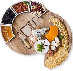 an assortment of cheeses and crackers on a wooden platter