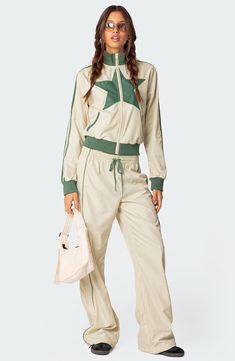 Channel your inner superstar in these slouchy track pants with contrasting details for edgy vibes. Drawstring waist Side-seam pockets 100% polyester Machine wash, dry flat Imported Tracksuit Aesthetic, Nylon Track Pants, Track Suits Women, Sporty Chic Style, Swimwear Dress, Sports Suit, Sporty Chic, Nylon Fabric, Sporty Look