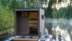 an outhouse sitting on top of a boat in the water