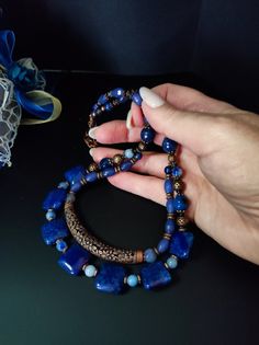 This is an ethnic style necklace made with large square dragon venis agate stones dyed blue. The necklace is double-stranded with a copper-plated brass decorative element in the center. To finish the necklace I also used agate, jade and lapiz stones. For those who love elegant retro style. All jewels are delivered in a decorated box, ready to be given as a gift to your loved one. How to take care of your jewellery: put on your beauty products (cosmetics, perfumes, ...) before wearing your precious jewel. Clean your jewelry with a soft cloth after wearing. Don't use water. Make sure you store your jewelry separately to avoid scratching it. Store away from heat sources, in a dry place in the special box. SHIPPING CONDITIONS I ship to the address you provided to us on Etsy, so be sure to chec Boho Style Necklaces, Ethnic Necklaces, Precious Jewels, Brass Decor, Agate Necklace, Necklace Boho, Blue Agate, Ethnic Style, Copper Plated