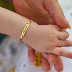 This Baby ID Bracelet is an embodiment of love and sentiment, making it an ideal gift. Uniquely designed to accommodate growth, it features a standard length of 4.5 inches and includes a 1.2-inch extension chain for easy adjustment as your baby grows. The bracelet is meticulously crafted from high-quality materials, combining 14K Solid Gold and 925 Sterling Silver, which guarantees both durability and a touch of sophistication. Additionally, it offers the option to personalize with your baby's n Baby Name Plate Bracelet, Boy Baby Bracelet Gold, Adjustable Nameplate Charm Bracelet, Adjustable Nameplate Bracelet With Names, Adjustable Nameplate Bracelets With Names, Custom Name Adjustable Heart Bracelet For Mother's Day, Baby Chain Designs Gold, Adjustable Names Bracelet Perfect As Gift, Adjustable Name Bracelets For Gifts