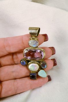 This gorgeous pendant is 925 silver, and set with a variety of semi-precious stones, including amethyst, pearl, opal and labradorite. It would look great on a man or woman, and would be a wonderful gift, even if its for yourself! This wonderful pendant will come to you in a gift box, ready for giving! Total weight on pendant is 24 grams, and it measures 2 1/2 inches by 1 1/4 inches. For more lovely vintage accessories, please visit: www.etsy.com/shop/CloesCloset?section_id=10559789 Multi-stone Moonstone Gemstones For Gift, Multi-stone Pendant Gemstones For Jewelry Making, Purple Multi-stone Pendant Gemstones, Fusion Style Amethyst Multi-stone Jewelry, Fusion Multi-stone Amethyst Jewelry, Multi-stone Amethyst For Jewelry Making, Fusion Style Multi-stone Amethyst Jewelry, Silver Multi-stone Pendant Gemstones, Sterling Silver Multi-stone Pendant Gemstones