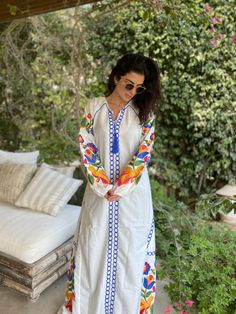 "This bohemian multicolour embroidery dress is a an eye catcher! It is an extremely comfortable wear, light and soft and can be used on many occasions - home gatherings, festival parties, summer occasions, dinners, or just in your home to feel comfortable. Fabric : 70% Egyptian Cotton; 30% Polyester. Kaftan measurements in inches : Medium (Size 8/10 USA) Bust : 39-40 Hip : 45-46 Large (Size 12/14 USA) Bust : 44-45 Hip : 50-51 XL (Size 16/18 USA) Bust : 47-48 Hip : 53-54 XXL (Size 20/22 USA) Bust Traditional Maxi Dress With Multicolor Embroidery, Spring Cotton Kaftan With Floral Embroidery, Traditional Multicolor Embroidered Maxi Dress, White V-neck Embroidered Dress For Festival, White Resham Embroidery Dress For Festival, Multicolor Tunic Kurta For Spring, Traditional Embroidered Multicolor Maxi Dress, Spring Folk Style Kaftan With Geometric Embroidery, Traditional Long Sleeve Maxi Dress With Multicolor Embroidery