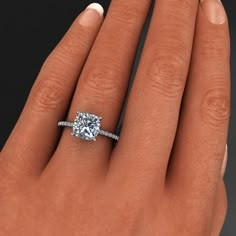 a woman's hand with a diamond ring on her finger and an engagement band