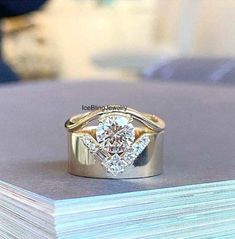 a diamond ring sitting on top of a stack of books