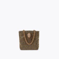 This Mini Party Tote Purse features a gold crystal exterior. There is a gold eagle head embellished with gold crystals sat on the front6.2in (H), 7in (L), 1.5in (D)Strap length: 12inTwo gold chain top handlesTextured interior liningPlease take extra care when styling this piece with delicate fabricsCan fit phones up to 7inchesMaterial: CrystalsStyle number: 3574861999 Formal Gold Bag With Gold-tone Logo Plaque, Gold Rectangular Bag With Gold-tone Logo Plaque, Party Bags With Gold-tone Logo Plaque, Luxury Gold Shoulder Bag For Party, Gold Luxury Evening Bag With Chain Strap, Glamorous Gold Embellished Shoulder Bag, Luxury Evening Bag With Gold-tone Hardware For Party, Gold Rhinestone Shoulder Bag For Formal Occasions, Formal Gold Shoulder Bag With Rhinestones