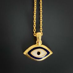 The Dainty Evil Eye Necklace is perfect for you if you're looking for something simple to wear every day. This beautiful necklace features a small evil eye charm on a sterling silver chain and will brighten your day with its protective energy and bring you good luck. This necklace comes in a silver and a 18k gold plated variant. The Dainty Evil Eye Necklace also has a matching bracelet and earrings. The Evil Eye bead is a prominent symbol in Turkish and many other cultures, and is highly protect Amulet Pendant Charm Necklace, Yellow Gold Evil Eye Spiritual Necklace, Spiritual Yellow Gold Necklace With Evil Eye, Spiritual Gold Eye-shaped Necklace, Spiritual Yellow Gold Evil Eye Necklace, Symbolic Good Luck Pendant Necklace, Spiritual Pendant Charm Necklaces With Delicate Chain, Symbolic Charms Pendant Necklaces, Symbolic Pendant Necklaces With Charms