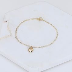 "14k Gold Heart Bracelet - Dainty 14K Gold Bracelet ★ The chain is 14k solid gold ★ The components are 14K yellow gold ★ The small heart charm is about 11 mm x 6mm, it is hollow 14k gold. The length includes the chain and the closure. ** How to choose a correct size of bracelet. 1. Measure your wrist below the wrist bone using a flexible tape measures, a string or a strip of paper. 2. If using a string or a strip of paper, mark length. Then, measure it with a ruler. 3. To find the bracelet size, 14k Gold Jewelry With Heart Charm For Everyday, 14k Gold Delicate Heart Charm Jewelry, Dainty 14k Yellow Gold Filled Bracelet, 14k Gold Bracelet With Heart Charm For Everyday, Everyday Gold Chain Bracelet With Heart Charm, Dainty Yellow Gold Charm Bracelet For Everyday, Everyday 14k Gold Bracelet With Heart Charm, Dainty Yellow Gold Everyday Charm Bracelet, Dainty 14k Gold Jewelry With Heart Charm