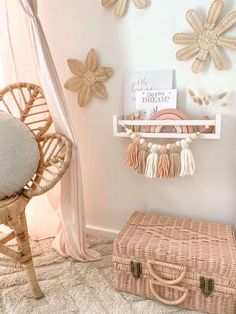 a pink and white bedroom with wicker furniture, wall hangings and decorative accessories