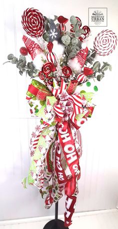 a christmas wreath with candy canes and ribbons