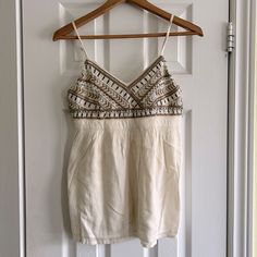 Hollister White Beaded Tank Top Size: Small Never Worn 55% Cotton, 45% Viscose Summer V-neck Beaded Top, Summer Beaded V-neck Tops, Beaded V-neck Tops For Summer, Beaded V-neck Top For The Beach, Chic Summer Tops With Beaded Straps, Summer White Beaded Top, White Beaded Top For Summer, Summer Beige Beaded Tops, Summer Beaded Beige Tops