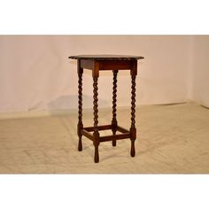 a small wooden table sitting on top of a hard wood floor