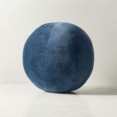 a large blue ball sitting on top of a white table