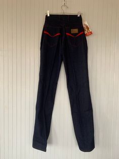 "Rare NWT Vintage Early 80s High Waisted Dark Denim Blue Jeans, by Hush Puppies. New condition and unworn with original tags. Super high rise waist. Front & back pleated down center of leg. Dark denim with red stitching, embroidered back pockets with basset hound logo. Amazing Original condition with original store tags! Brand - Hush Puppies Condition - Original. Deadstock from the 80s, New with original tags 100% Cotton Made in Taiwan Machine Washable Vintage Size - 8 Size - 26\" waist Best Retro Stretch Flare Jeans, Retro Fitted Denim Bottoms, Retro Fitted Medium Wash Jeans, Vintage Stretch Denim Blue Jeans, Medium Wash Retro Fitted Jeans, Retro Fitted Straight Leg Jeans, Retro High Waist Fitted Jeans, Retro Fitted High Waist Jeans, Retro Jeans With Standard Cut Leg