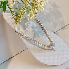 Rhinestones Bridal Flip Flops, custom crystal bridal sandals, Rhinestone shoes for beach destination wedding - custom color your choice Cute wedding flip flops, made with flat white flip flops, silver stone chain and silk thread for extra softness. The thread can change according to the colors of your wedding, let me know how you want them and I will design them for you on that special day Also available with golden rhinestones Beautiful sandals for beach / summer weddings and for a bridal party Bedazzled Silver Sandals For The Beach, Silver Bedazzled Sandals For Beach, Silver Bedazzled Sandals For The Beach, Bedazzled Open Toe Wedding Sandals, Bedazzled Open Toe Sandals For Wedding, White Rhinestone Sandals For Vacation, Silver Open Toe Flip Flops With Rhinestones, Elegant Silver Beach Flip Flops, Silver Rhinestone Open Toe Flip Flops