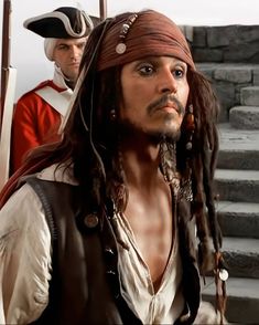 a man dressed as captain jack sparrow with dreadlocks on his head and chest